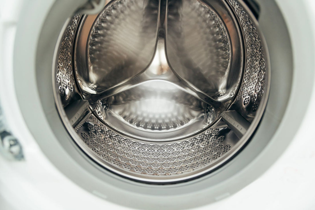 Close up of an open washing machine drum and its rubber door seal