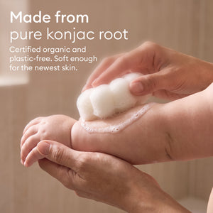 Baby Konjac Sponges: parent washing a baby's foot with the flower sponge, made from pure konjac root