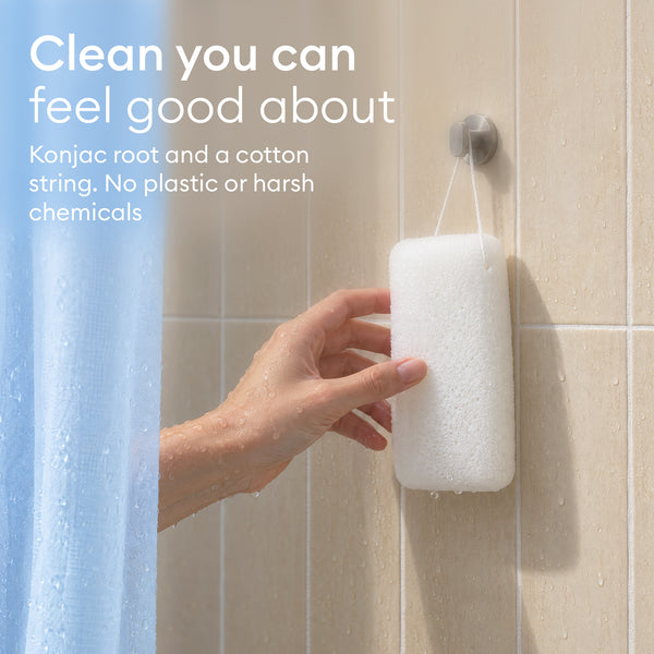 Konjac Body Sponge: hand hanging a white sponge on a shower hook by its cotton string
