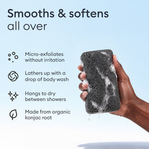 Konjac Body Sponge: hand holding a lathered charcoal sponge, micro-exfoliates without irritation