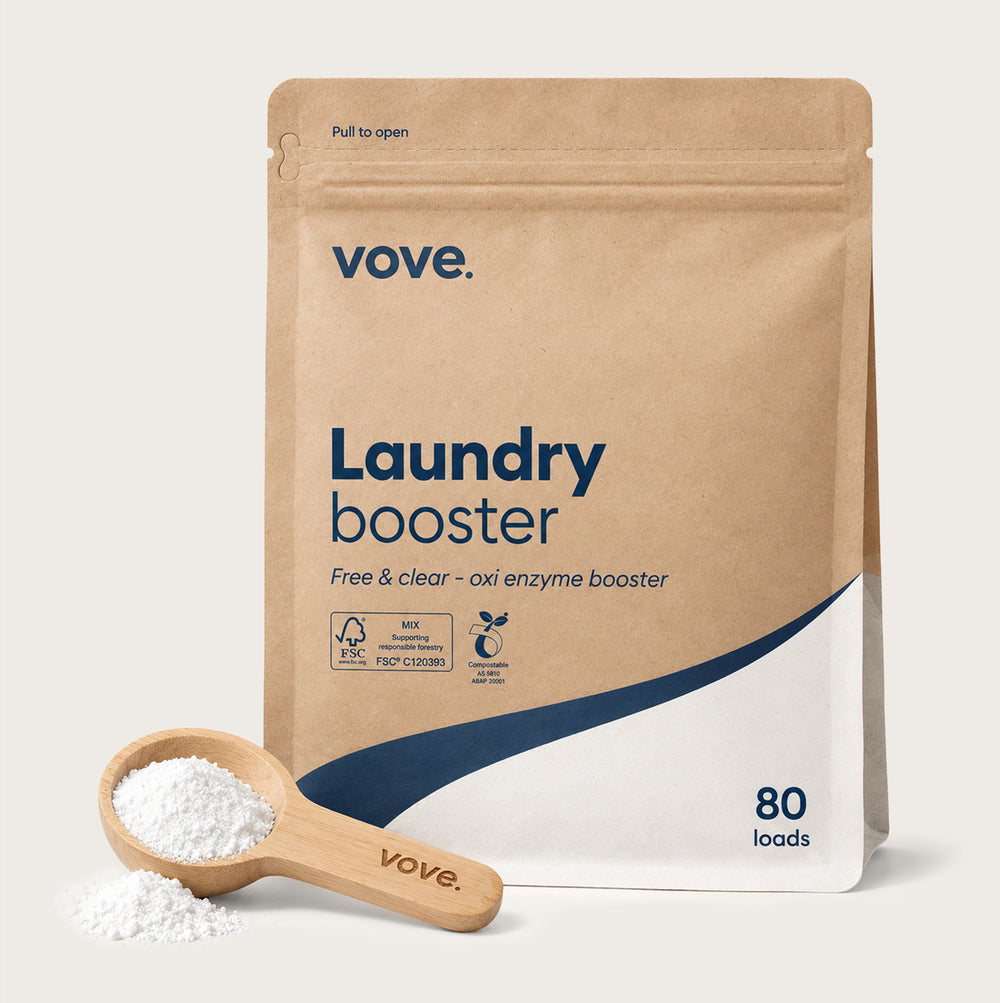 Laundry booster: kraft pouch of fragrance-free enzyme booster with its wooden measuring scoop