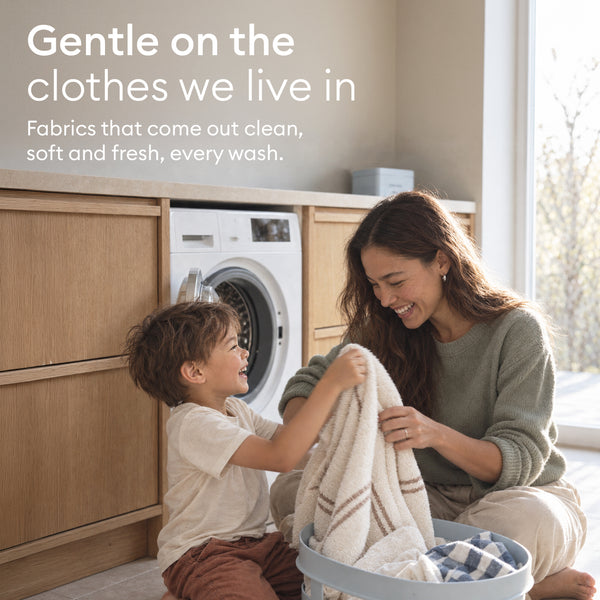 The Tablet Detox: parent and child folding laundry by the washing machine, fabrics that come out clean and soft