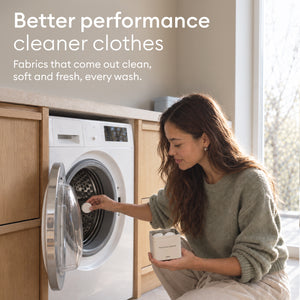Machine Cleaner Set: woman placing a tablet in the empty drum, for clothes that come out clean and fresh