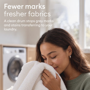 Washing Machine Cleaner Tablets: woman holding a freshly washed towel, a clean drum stops grey marks transferring to laundry