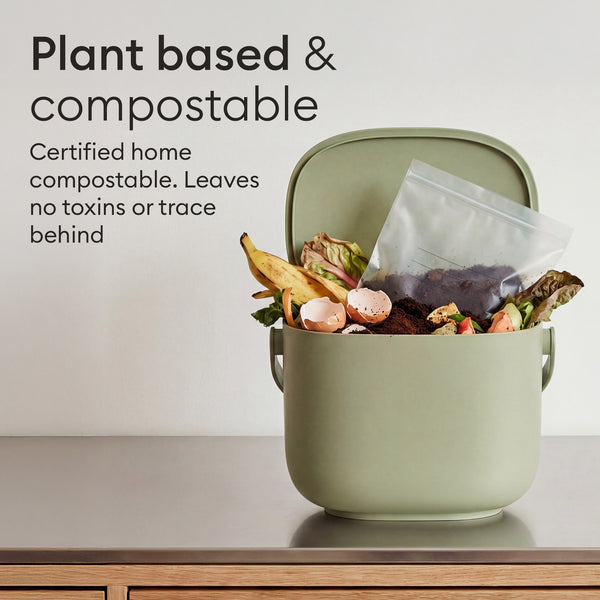 Compostable Zip Bags: used bag going into a compost caddy, certified home compostable